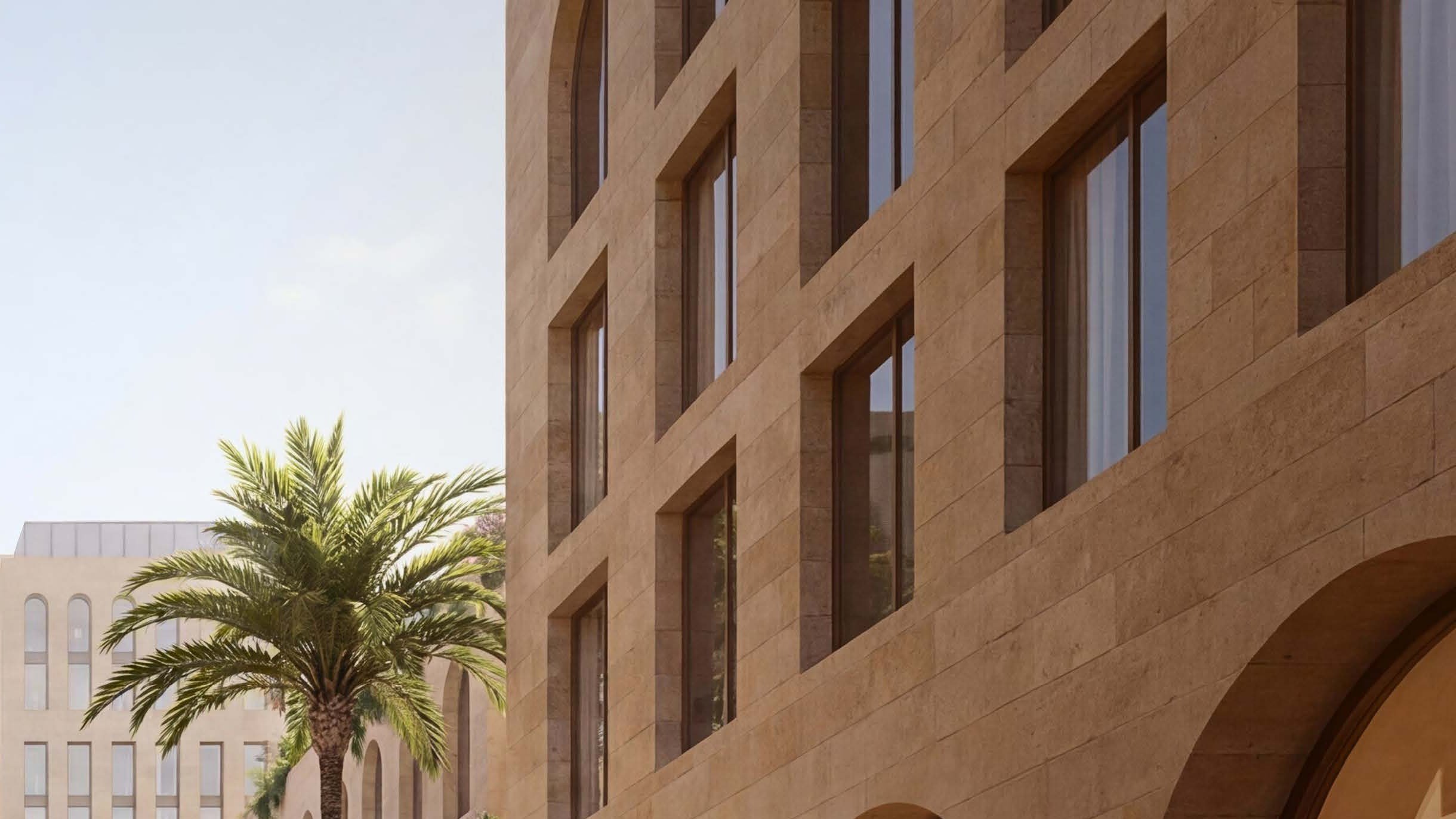 A limestone facade in raking light — deep-set arched openings and ashlar coursing, drawn to be built.